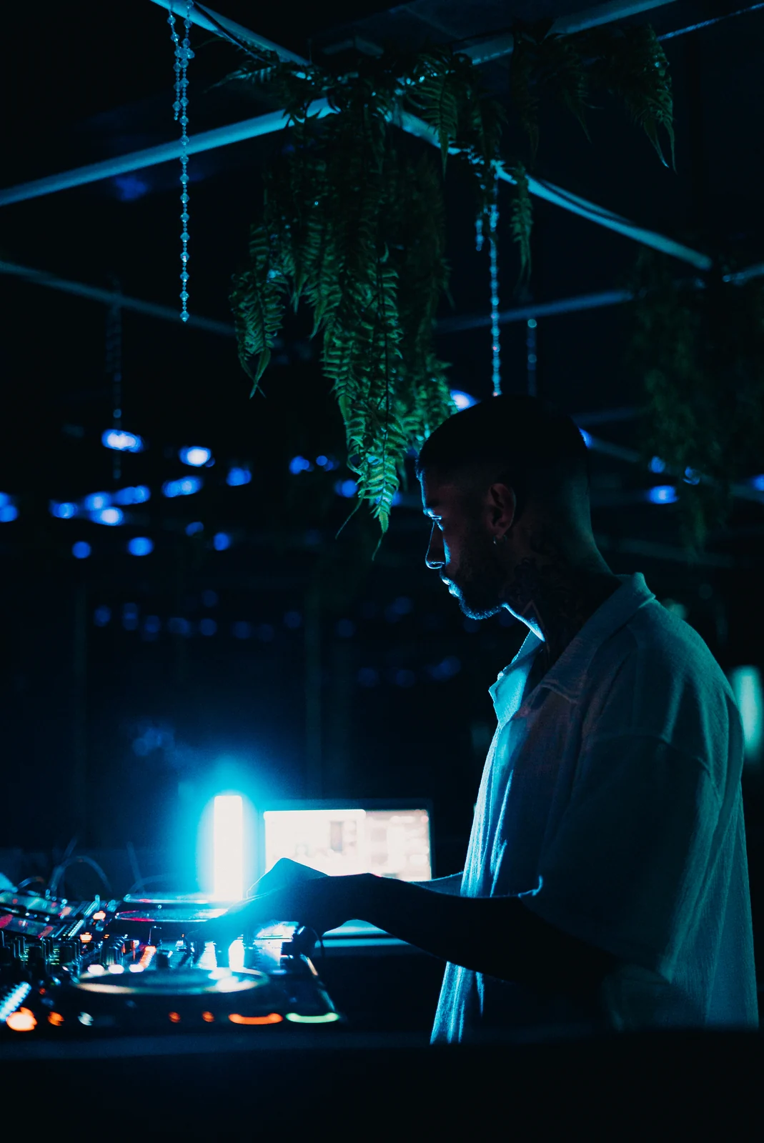 LAIR playing live, cyan light over the booth